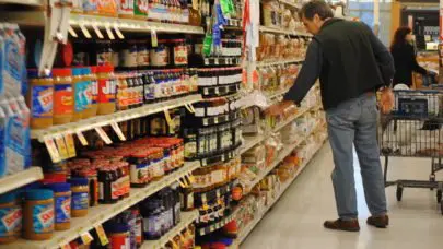 man shopping for bread at a grocery store—a prime location to encounter product liability risks.