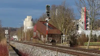 railway station with abandoned cargo cars on the side, meant to represent the article "Railroad Law: Three Class Action Case Examples" by MMRBH Law Office.