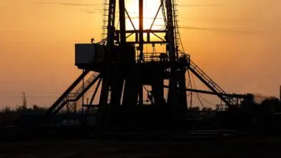 A photo of an oil rig silhouetted by the setting sun. Oil rigs are one of the leading perpetrators of accidents in the oil and gas industry.