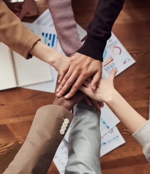 several hands placed on top of each other in solidarity of a class action lawsuit case